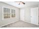 Neutral-toned bedroom with carpet, natural light, and door at 832 Toonigh Rd, Canton, GA 30115