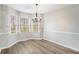 Bright dining area with neutral walls, laminate flooring, a chandelier, and natural light from multiple windows at 832 Toonigh Rd, Canton, GA 30115