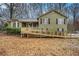 Charming two-story home with wood siding, black shutters, and a spacious front yard with a wooden ramp at 832 Toonigh Rd, Canton, GA 30115