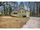 Inviting two-story home with a wooden ramp and driveway, surrounded by mature trees and a spacious yard at 832 Toonigh Rd, Canton, GA 30115