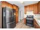 Well-equipped kitchen with stainless steel appliances, ample wooden cabinetry, and durable laminate flooring at 832 Toonigh Rd, Canton, GA 30115