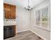 Cozy eat-in kitchen with wood cabinets, laminate flooring, a chandelier and a view from a window at 832 Toonigh Rd, Canton, GA 30115