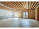 Unfinished basement with concrete floor, exposed ceiling, framing and walkout door at 1621 Annapolis Way, Grayson, GA 30017