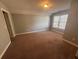 Neutral bedroom featuring carpeting, windows, and closet at 1621 Annapolis Way, Grayson, GA 30017