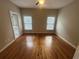 Bedroom with hardwood floors, two windows, and a ceiling fan at 1621 Annapolis Way, Grayson, GA 30017