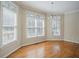 Sunlit dining area featuring hardwood floors, neutral paint, and large windows with wooded views at 1621 Annapolis Way, Grayson, GA 30017