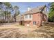 Stately two-story brick home with a balcony overlooking the backyard and mature trees at 1621 Annapolis Way, Grayson, GA 30017