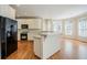 Stylish kitchen featuring white cabinets, black appliances, hardwood floors, and a bright breakfast nook at 1621 Annapolis Way, Grayson, GA 30017