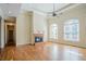 Inviting living room featuring hardwood floors, a brick fireplace, and tall ceilings with natural lighting at 1621 Annapolis Way, Grayson, GA 30017