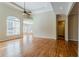 Open-concept living room featuring hardwood floors, ceiling fan, and neutral paint at 1621 Annapolis Way, Grayson, GA 30017