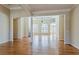 Spacious living room featuring hardwood floors, arched windows, and an open floor plan at 1621 Annapolis Way, Grayson, GA 30017