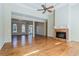 Spacious living room with a brick fireplace, hardwood floors, and large windows offering plenty of natural light at 1621 Annapolis Way, Grayson, GA 30017