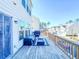 A pleasant back deck features blue outdoor furniture and a calming view of neighboring homes at 361 Watson Ave, Woodstock, GA 30189