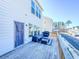 A pleasant back deck features blue outdoor furniture and a calming view of neighboring homes at 361 Watson Ave, Woodstock, GA 30189