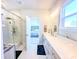 Bright bathroom with double vanity, glass shower and tile flooring that flows into a bedroom at 361 Watson Ave, Woodstock, GA 30189