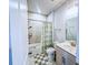 Well-lit bathroom features a shower-tub combo, patterned rug, and neutral color palette at 361 Watson Ave, Woodstock, GA 30189