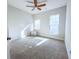 Bright bedroom featuring neutral walls, carpet, ceiling fan, and natural light from two windows at 361 Watson Ave, Woodstock, GA 30189