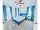 Cozy bedroom with a blue bed, two windows, and blue curtains at 361 Watson Ave, Woodstock, GA 30189