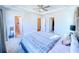 Bright bedroom featuring a ceiling fan, tray ceiling, and ensuite bathroom at 361 Watson Ave, Woodstock, GA 30189