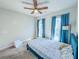 Well-lit bedroom featuring a bed, two windows with curtains, and ceiling fan at 361 Watson Ave, Woodstock, GA 30189