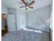 Cozy bedroom with neutral carpet, ceiling fan, and ample lighting from the window at 361 Watson Ave, Woodstock, GA 30189