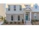 Inviting townhome exterior with classic design, featuring a stylish teal front door adorned with a floral wreath at 361 Watson Ave, Woodstock, GA 30189