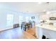 Bright kitchen and dining area with hardwood floors and modern pendant lighting at 361 Watson Ave, Woodstock, GA 30189