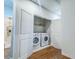 Conveniently placed washer and dryer units tucked away in a closet with double doors at 361 Watson Ave, Woodstock, GA 30189