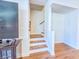 Staircase with wooden treads, decorative carpet, and a view of the second-floor landing at 361 Watson Ave, Woodstock, GA 30189