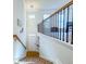 Bright foyer with a hardwood staircase leading to an upstairs hallway and railing at 361 Watson Ave, Woodstock, GA 30189