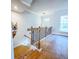 Grand stairway featuring dark hardwood flooring, iron spindles and an open, light-filled foyer at 361 Watson Ave, Woodstock, GA 30189