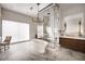 Bright bathroom with marble floors, a soaking tub, glass shower, and wood vanity at 79 Beverly Ne Rd, Atlanta, GA 30309