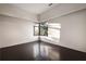 A modern bedroom with dark wood floors, white walls, and natural light through the window at 79 Beverly Ne Rd, Atlanta, GA 30309