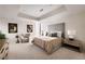 Bright bedroom featuring a tray ceiling, neutral tones, and modern decor at 79 Beverly Ne Rd, Atlanta, GA 30309