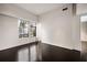 Bright bedroom with dark wood floors, white walls, and a large window at 79 Beverly Ne Rd, Atlanta, GA 30309