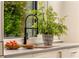 Modern kitchen features a gray countertop and stainless steel faucet with a view of the greenery outside at 79 Beverly Ne Rd, Atlanta, GA 30309