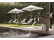 Beautiful outdoor pool area with lounge chairs, umbrellas, fountain, and meticulously maintained landscaping at 79 Beverly Ne Rd, Atlanta, GA 30309