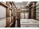 Spacious walk-in closet with custom wood cabinets, display island, and sleek lighting at 79 Beverly Ne Rd, Atlanta, GA 30309