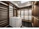 Walk-in closet boasts custom wood cabinetry, glass shelves, and a center island at 79 Beverly Ne Rd, Atlanta, GA 30309