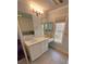 Bright bathroom featuring a vanity with drawers, decorative mirror, and ample natural light at 7155 Roswell Rd # 37, Sandy Springs, GA 30328