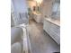 Bright bathroom featuring tiled floors, double sinks, and a soaking tub at 7155 Roswell Rd # 37, Sandy Springs, GA 30328