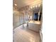 Cozy bathroom featuring wallpapered walls, vanity with sink, and a bathtub with sliding door at 7155 Roswell Rd # 37, Sandy Springs, GA 30328