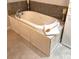 Luxurious soaking tub surrounded by elegant tilework and custom cabinetry at 7155 Roswell Rd # 37, Sandy Springs, GA 30328