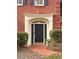 Elegant front door with decorative trim, sidelights, and brick walkway at 7155 Roswell Rd # 37, Sandy Springs, GA 30328