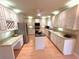 Well-lit kitchen featuring custom cabinetry, stainless steel appliances, and a breakfast bar at 7155 Roswell Rd # 37, Sandy Springs, GA 30328