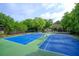 Two community tennis courts are surrounded by mature trees, offering a great space for exercise and recreation at 7155 Roswell Rd # 37, Sandy Springs, GA 30328