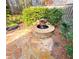 A backyard water feature is surrounded by lush greenery and a stone patio, creating a tranquil oasis at 7155 Roswell Rd # 37, Sandy Springs, GA 30328