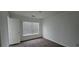 Bright and airy bedroom featuring a large window, neutral walls, and carpeted flooring at 911 Redwood Dr, Norcross, GA 30093