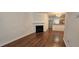 Cozy living area featuring wood floors, fireplace, and kitchen with stainless steel appliances at 911 Redwood Dr, Norcross, GA 30093