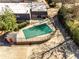 Aerial view of the community pool with protective cover and surrounded by fencing and greenery at 1106 Hampton Ne Way, Atlanta, GA 30324